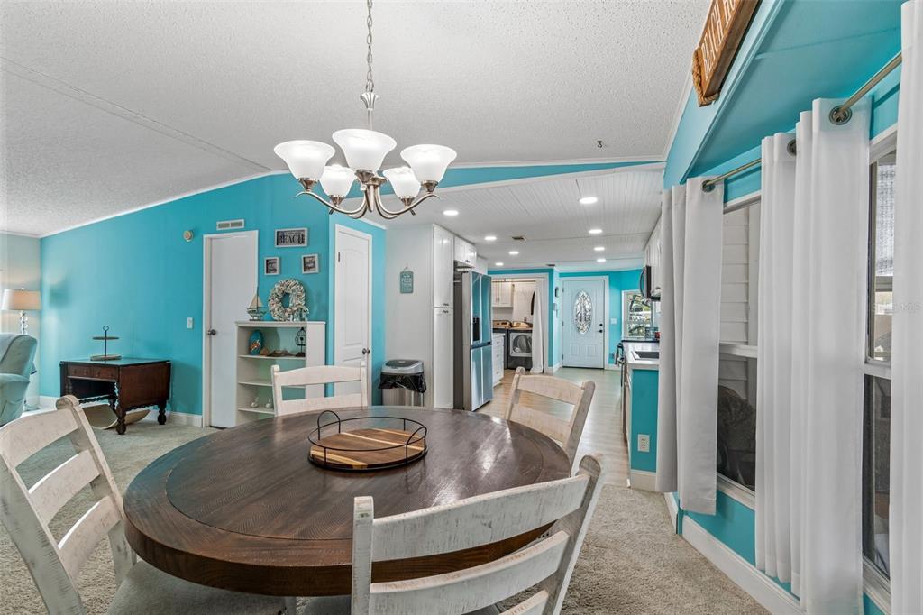 14242 Action Street Brooksville, FL 34613 - Photo 11 of 60 a dining room with furniture and a chandelier
