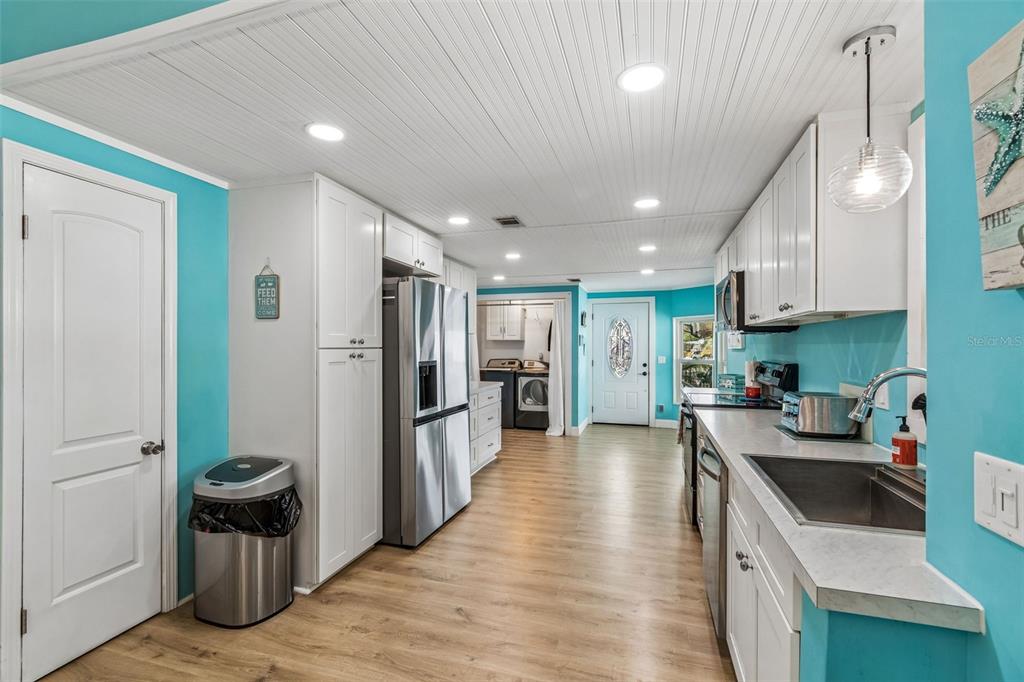 14242 Action Street Brooksville, FL 34613 - Photo 13 of 60 a kitchen with a refrigerator and a sink