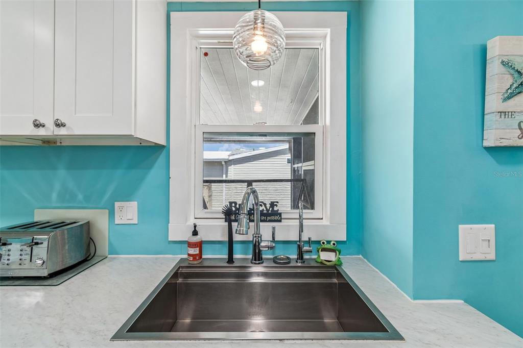 14242 Action Street Brooksville, FL 34613 - Photo 14 of 60 a kitchen with a sink and a mirror