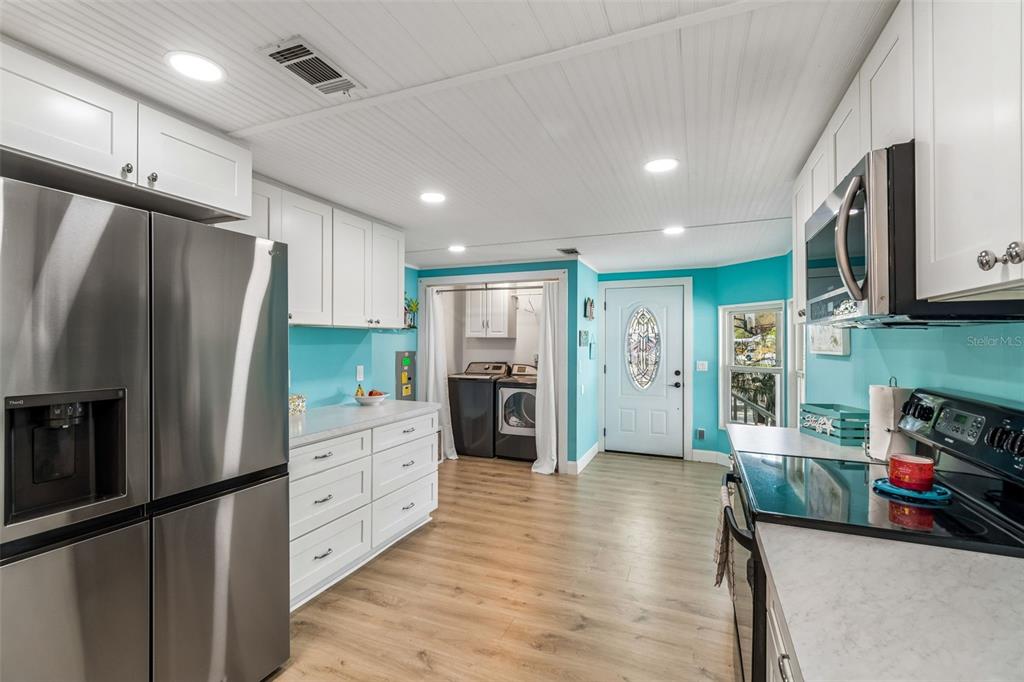 14242 Action Street Brooksville, FL 34613 - Photo 15 of 60 a kitchen with stainless steel appliances a refrigerator and a stove top oven