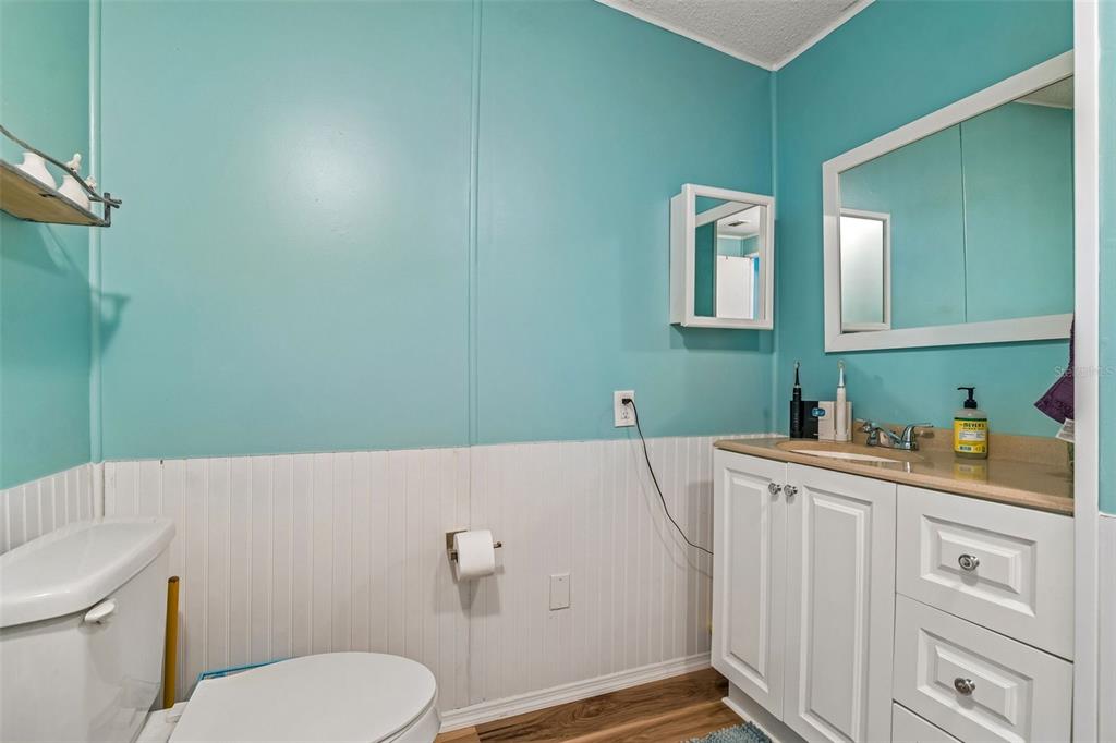 14242 Action Street Brooksville, FL 34613 - Photo 18 of 60 a bathroom with a sink a toilet and vanity