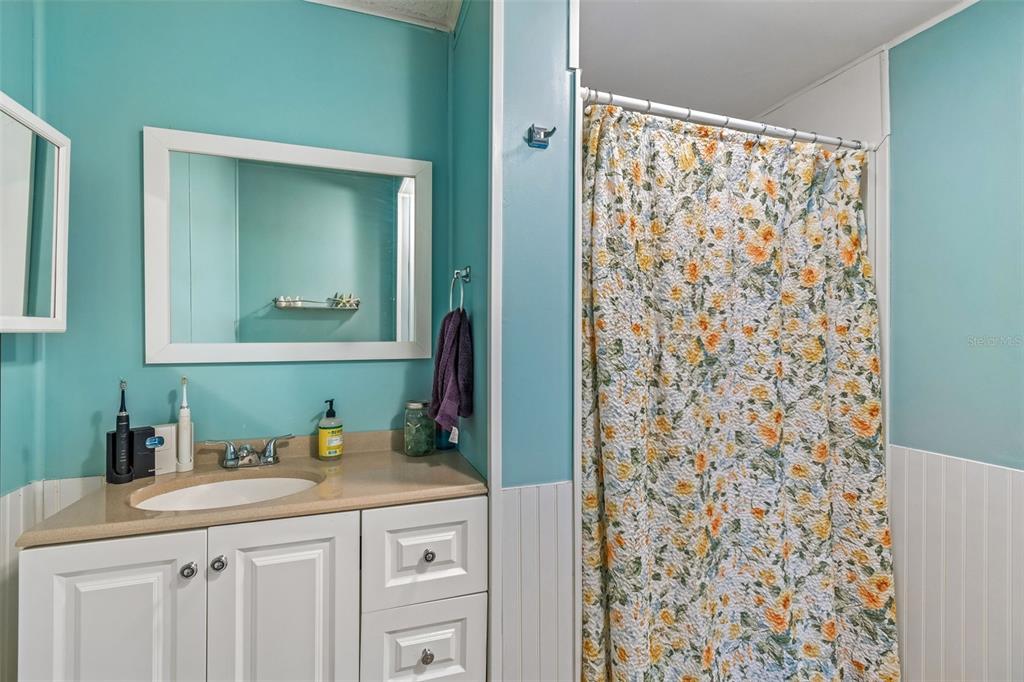 14242 Action Street Brooksville, FL 34613 - Photo 19 of 60 a bathroom with a sink and a mirror