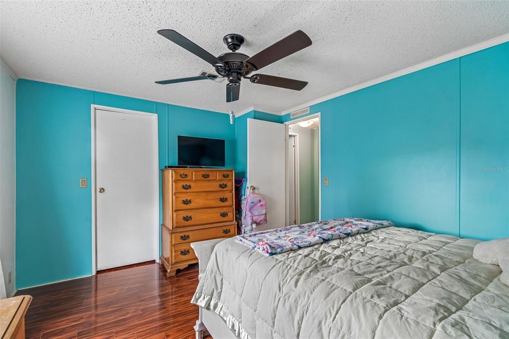 14242 Action Street Brooksville, FL 34613 - Photo 21 of 60 a bedroom with a bed and a flat screen tv
