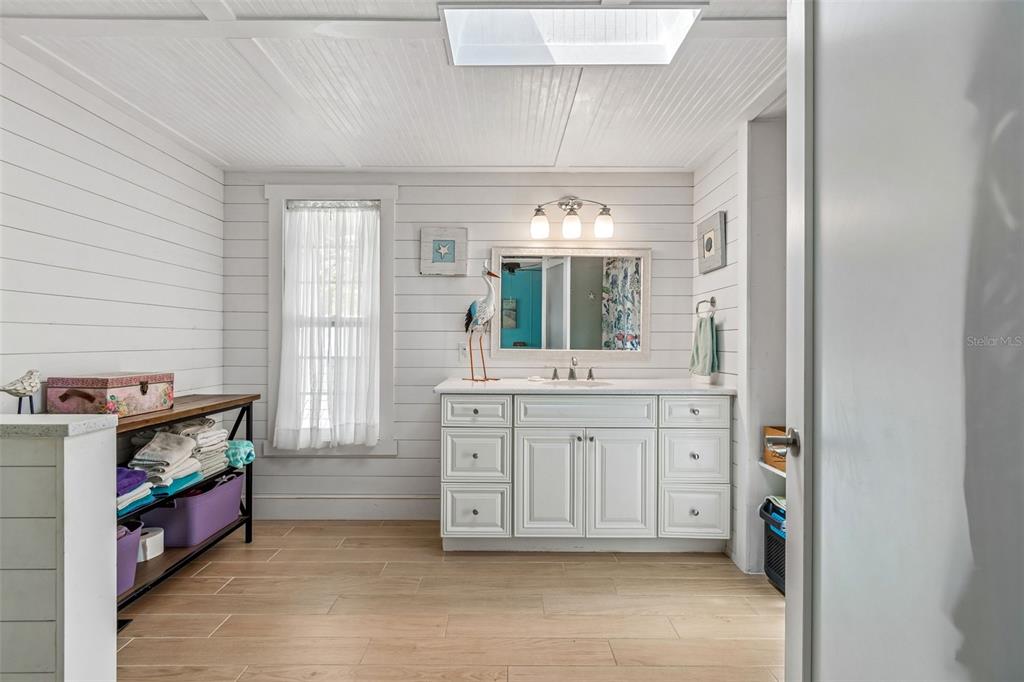 14242 Action Street Brooksville, FL 34613 - Photo 26 of 60 a spacious bathroom with a mirror and a sink