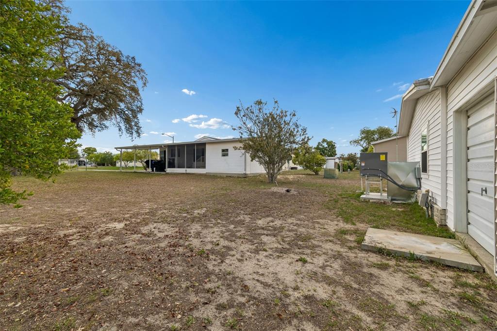 14242 Action Street Brooksville, FL 34613 - Photo 30 of 60 a view of a house with a yard