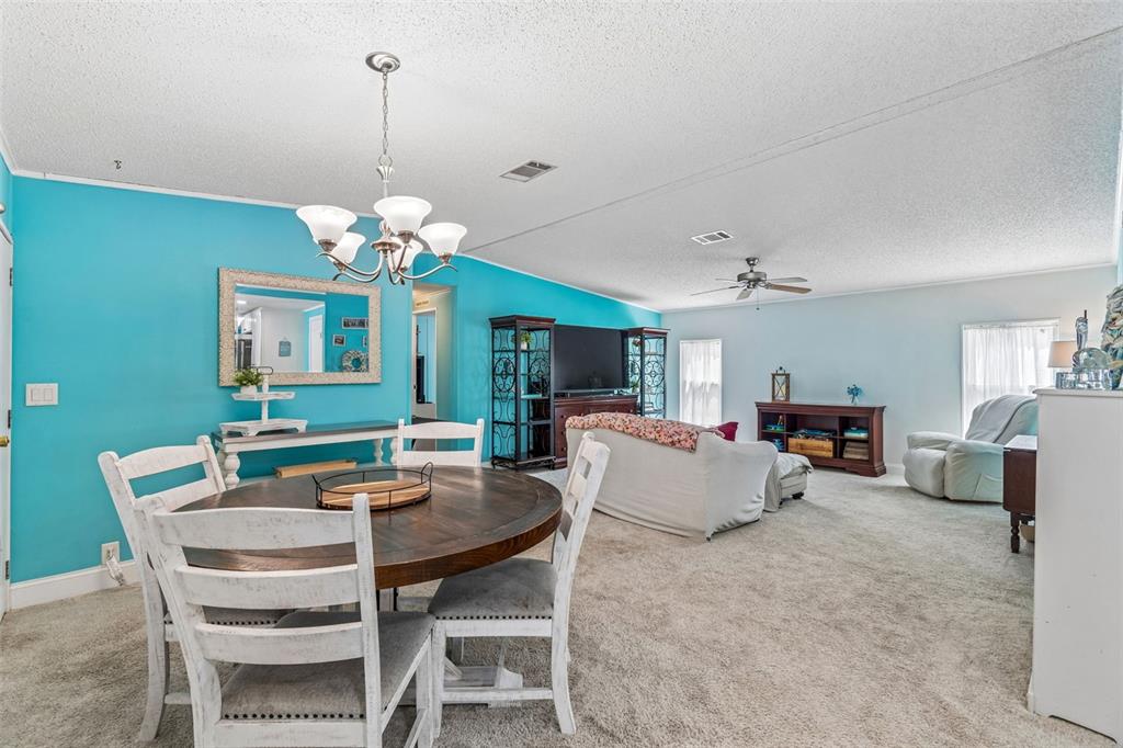 14242 Action Street Brooksville, FL 34613 - Photo 8 of 60 a view of a dining room with furniture and a chandelier
