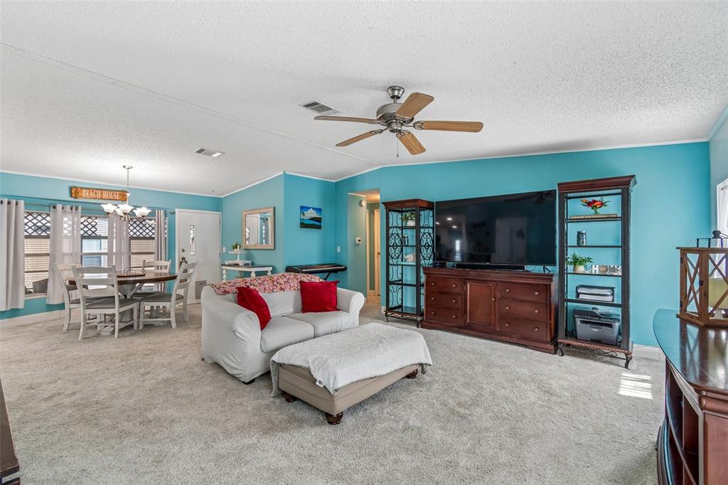 14242 Action Street Brooksville, FL 34613 - Photo 9 of 60 a living room with furniture a ceiling fan and a rug