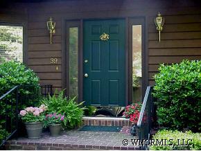 39 Hunting Country Road Tryon, NC 28782 - Photo 1 of 8 a view of a house with a potted plants and a bench in a patio