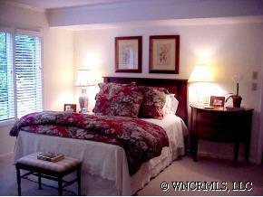 39 Hunting Country Road Tryon, NC 28782 - Photo 3 of 8 a bedroom with a bed and a table in it