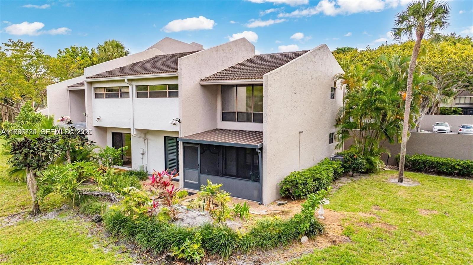149 Northwest 70th Street, Unit 101C Boca Raton, FL 33487 - Photo 1 of 21 a front view of a house with garden
