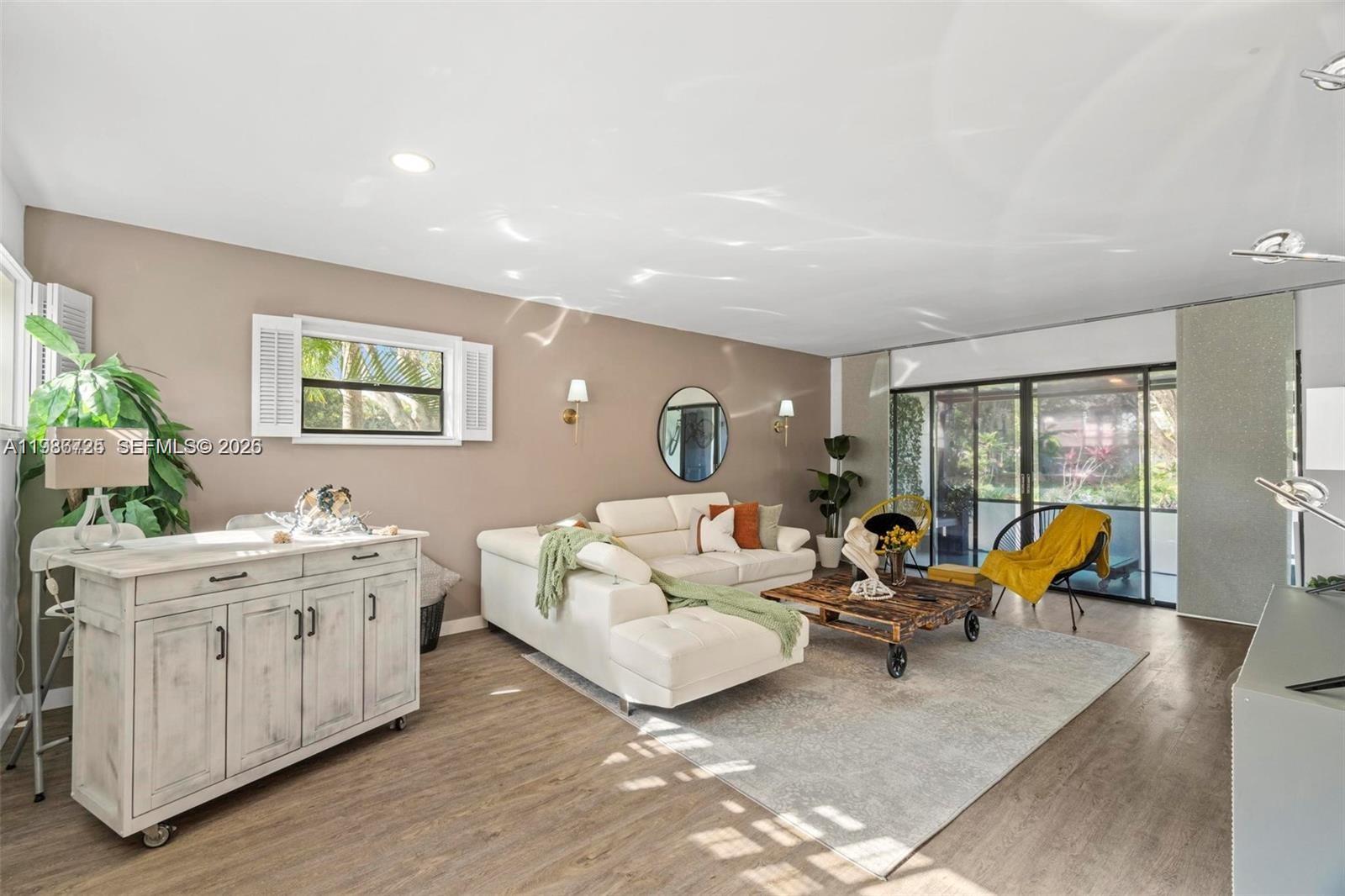 149 Northwest 70th Street, Unit 101C Boca Raton, FL 33487 - Photo 2 of 21 a living room with furniture and large windows