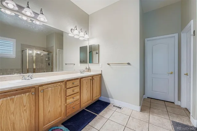 a bathroom with a double vanity sink and a mirror