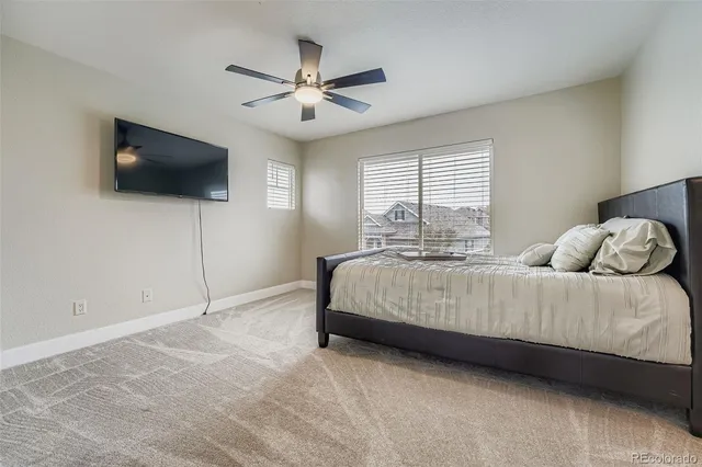 a bedroom with a large bed and a flat screen tv