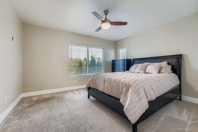 a bedroom with a large bed and a large window