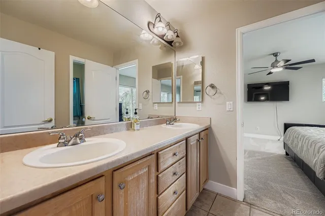 a spacious bathroom with a double vanity sink and a mirror