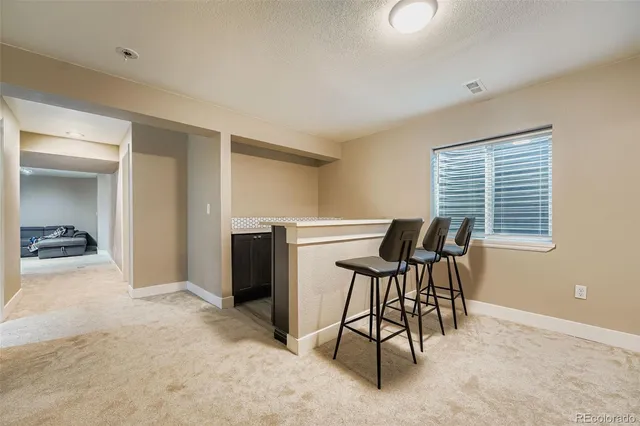 a view of a livingroom with furniture and a window