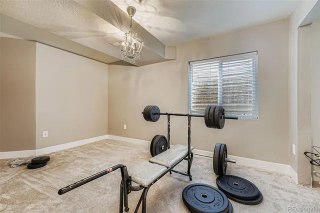 a view of entryway with workspace and a chandelier