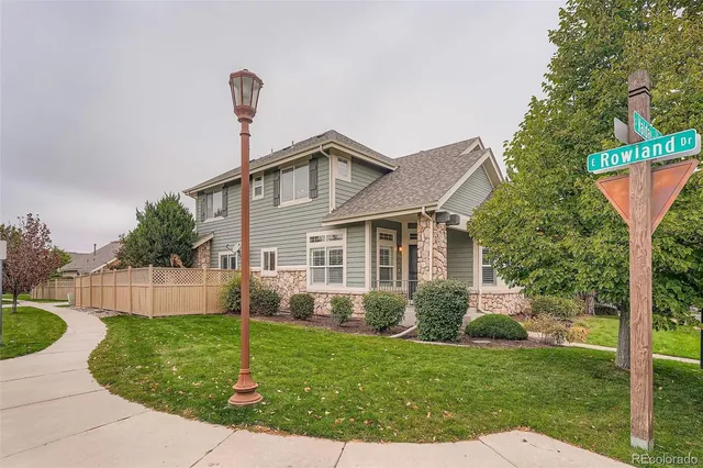 a front view of a house with a yard and trees