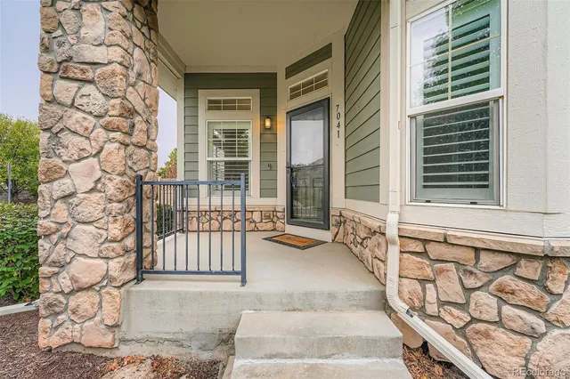 a view of a brick house with large windows