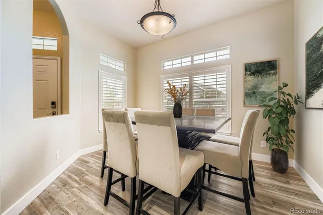 a dining room with furniture wooden floor and a potted plant