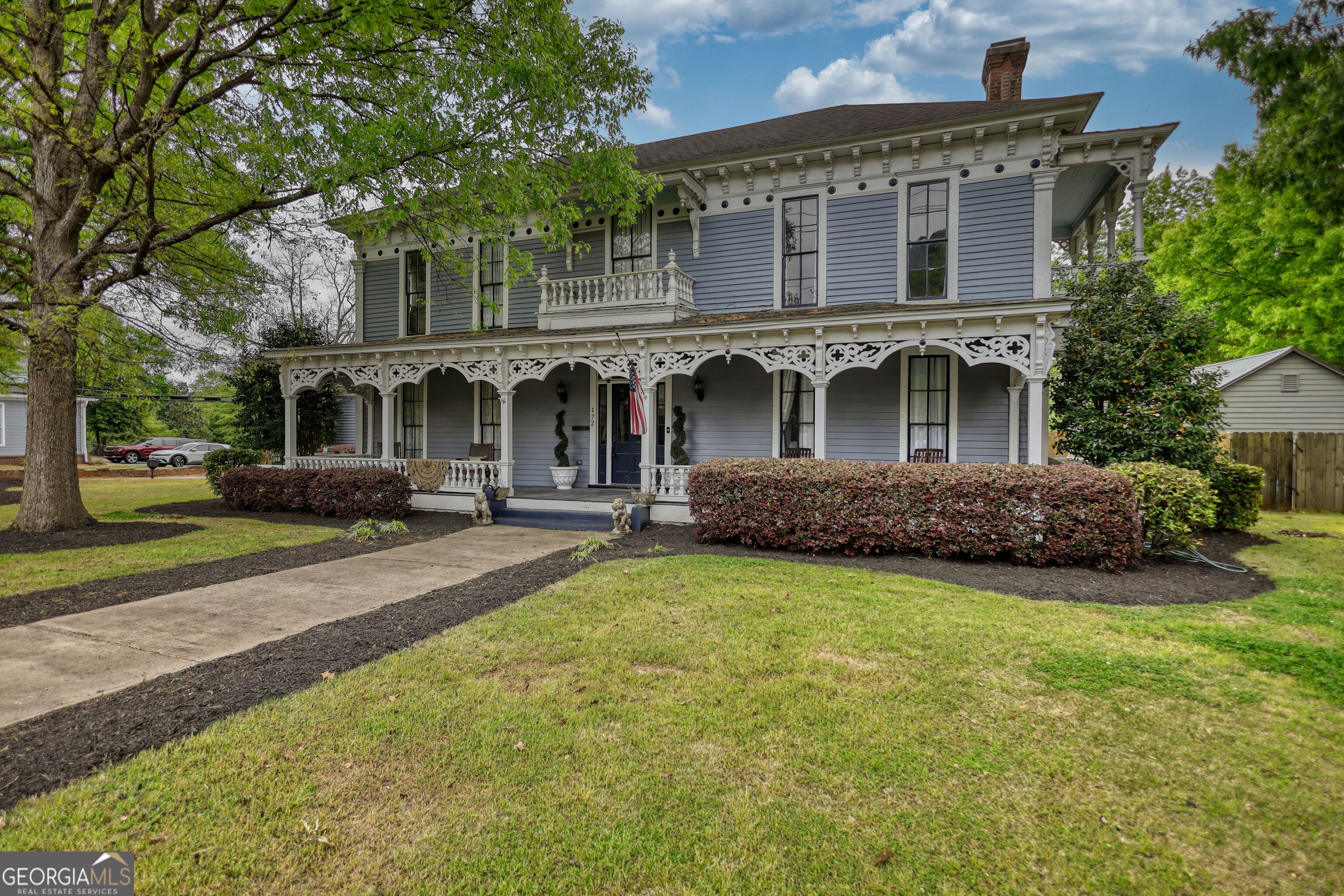 a front view of a house with a garden