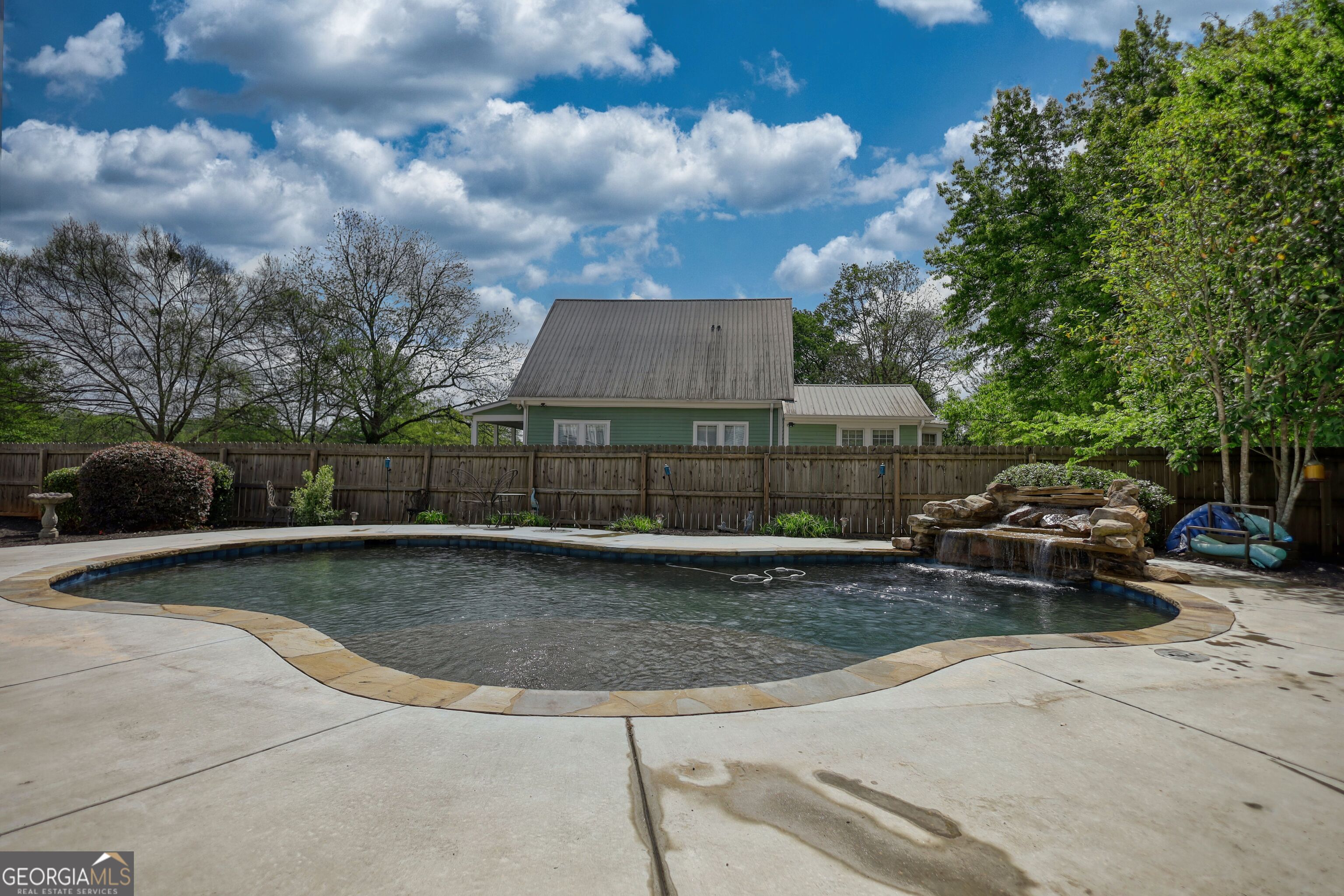 172 North 2nd Street Madison, GA 30650 - Photo 14 of 69 a view of swimming pool with seating space and trees in the background
