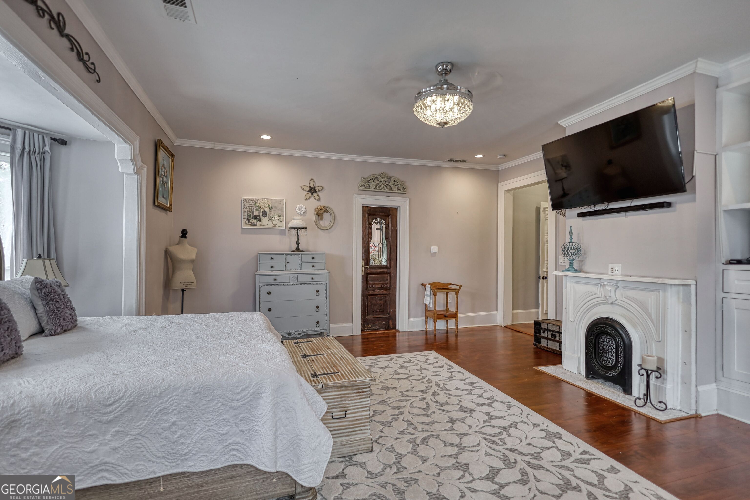 172 North 2nd Street Madison, GA 30650 - Photo 40 of 69 a spacious bedroom with a bed and a flat screen tv