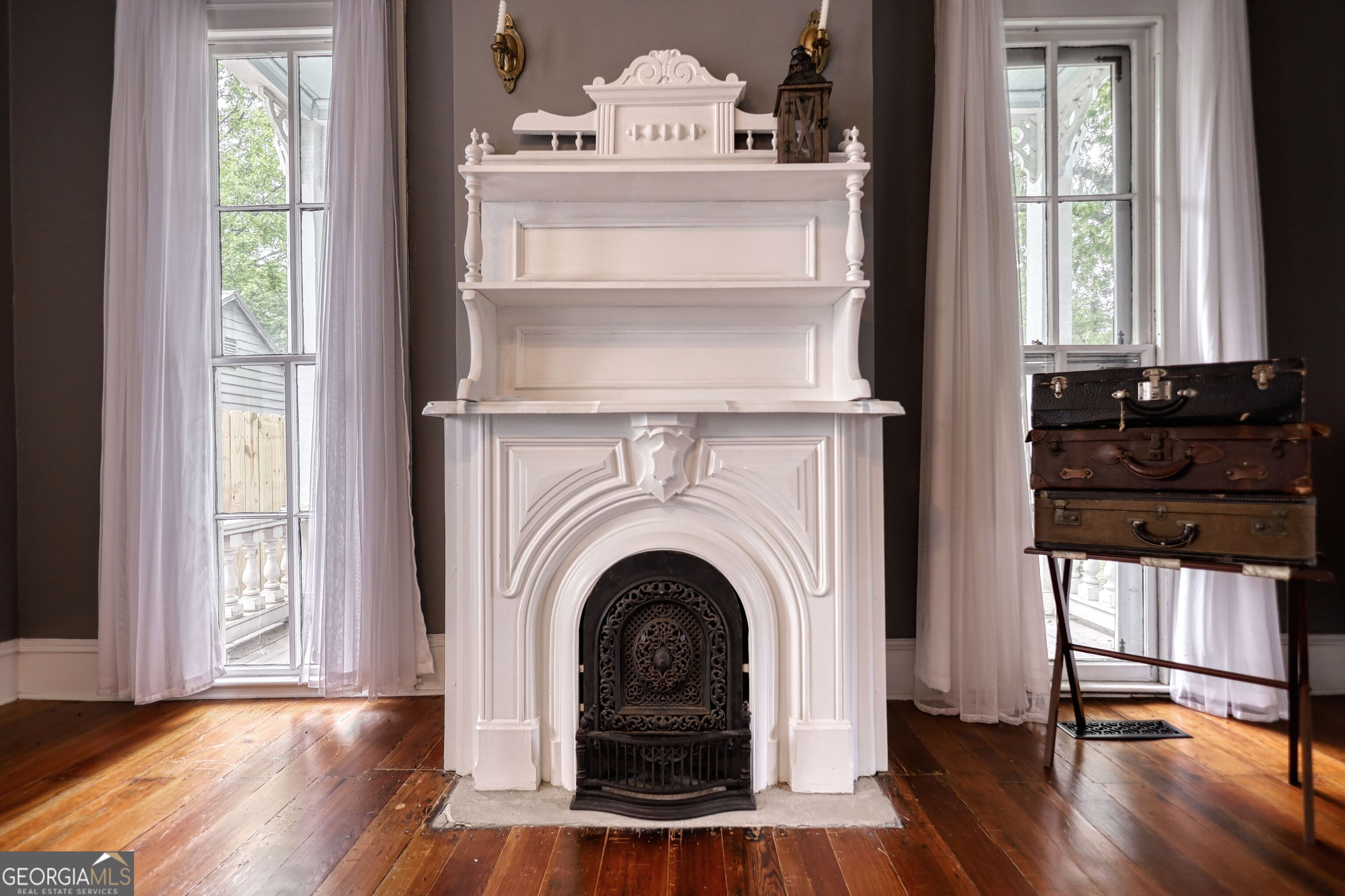 172 North 2nd Street Madison, GA 30650 - Photo 54 of 69 a view of a livingroom with a fireplace wooden floor and windows