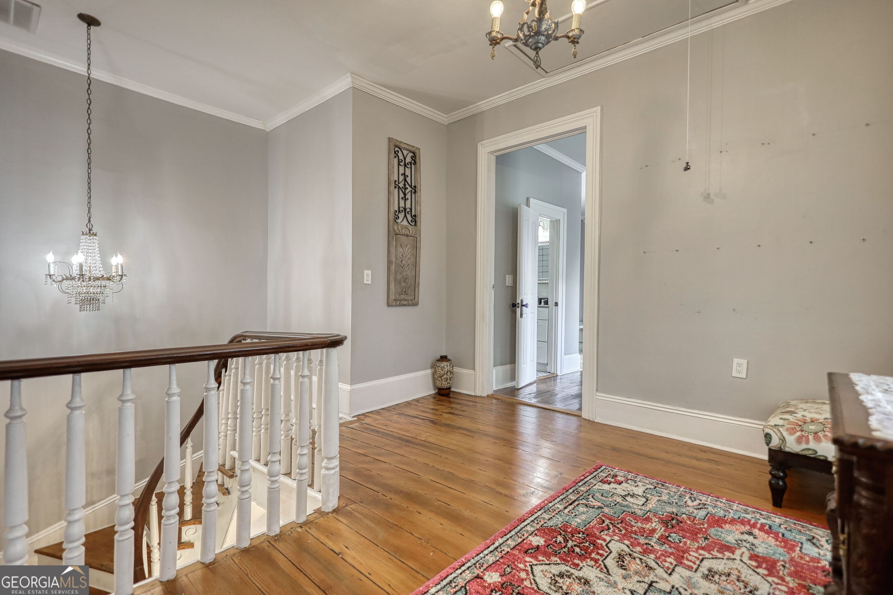 172 North 2nd Street Madison, GA 30650 - Photo 56 of 69 a view of a hallway with wooden floor and staircase