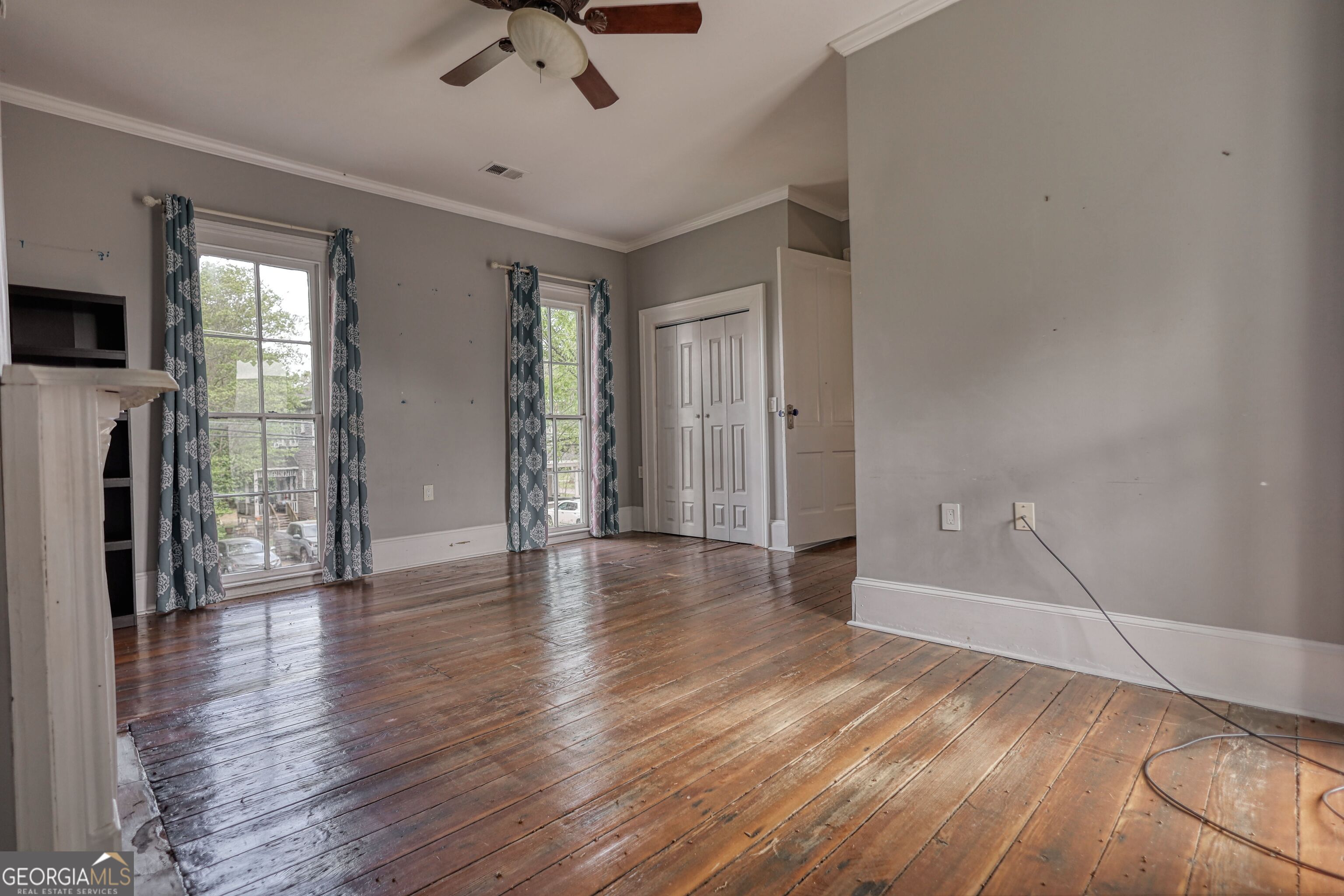 172 North 2nd Street Madison, GA 30650 - Photo 58 of 69 a view of a livingroom with wooden floor and a ceiling fan