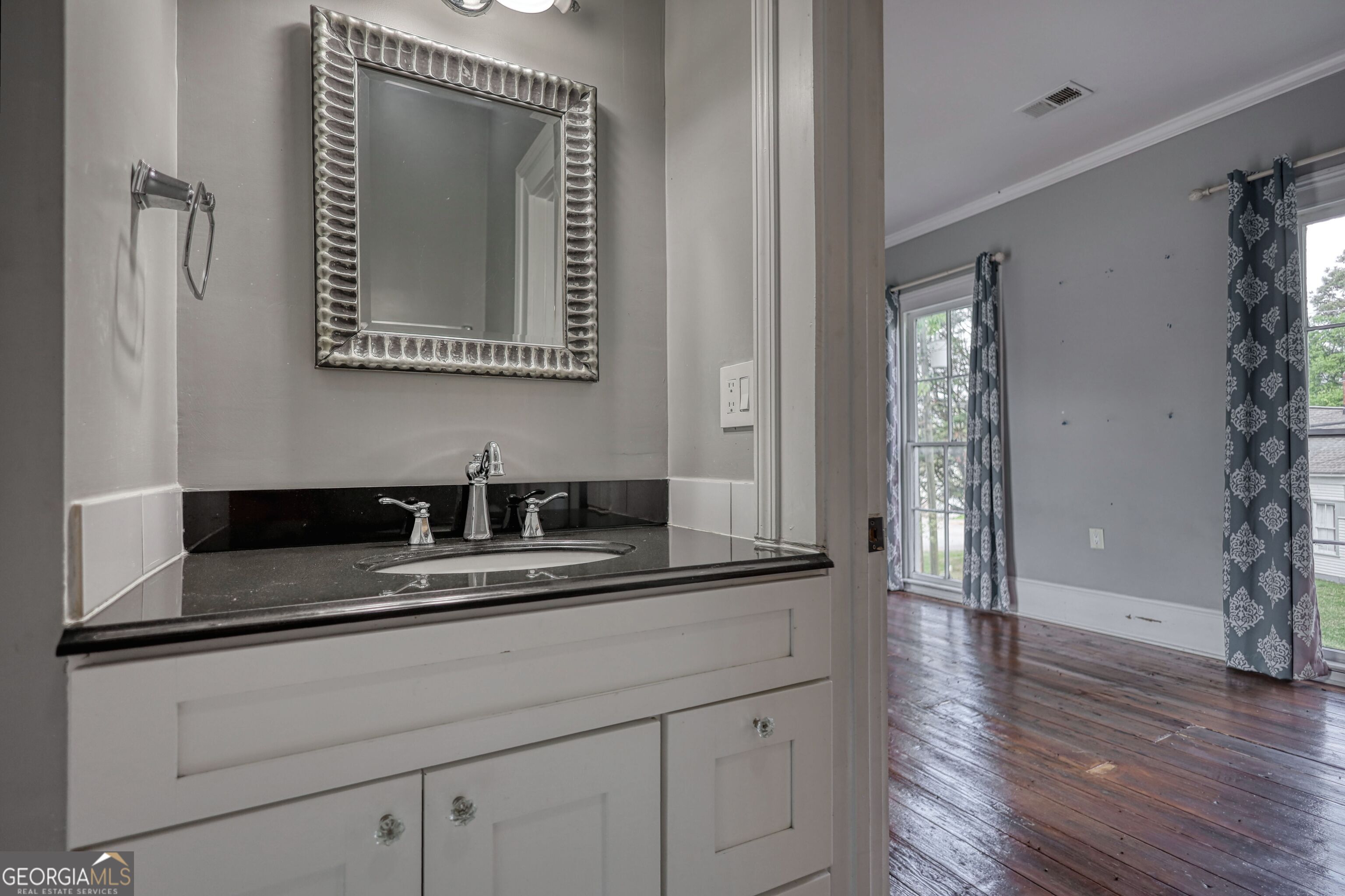 172 North 2nd Street Madison, GA 30650 - Photo 61 of 69 a bathroom with a sink and a mirror