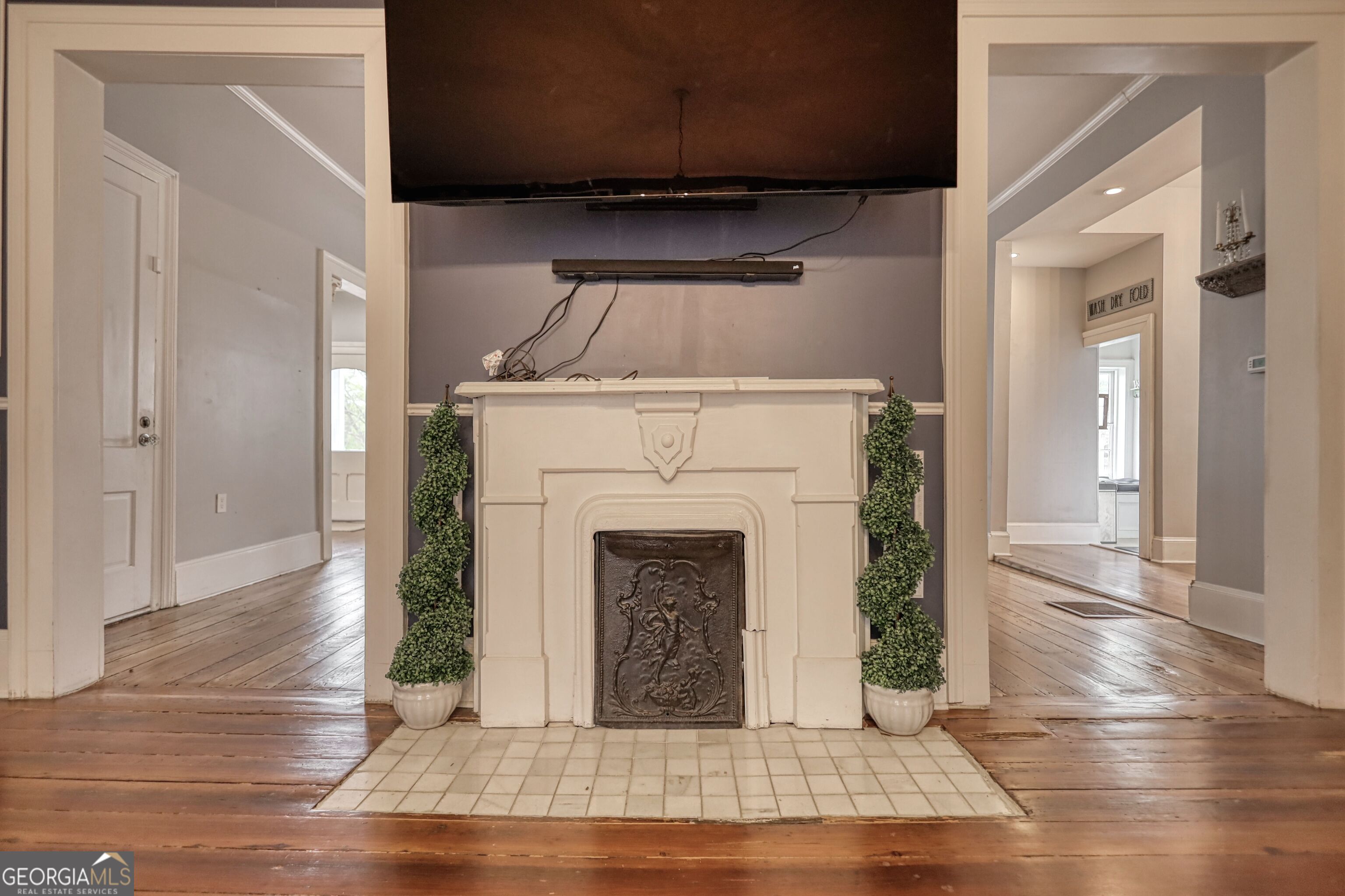 172 North 2nd Street Madison, GA 30650 - Photo 64 of 69 a living room with a fireplace and wooden floor