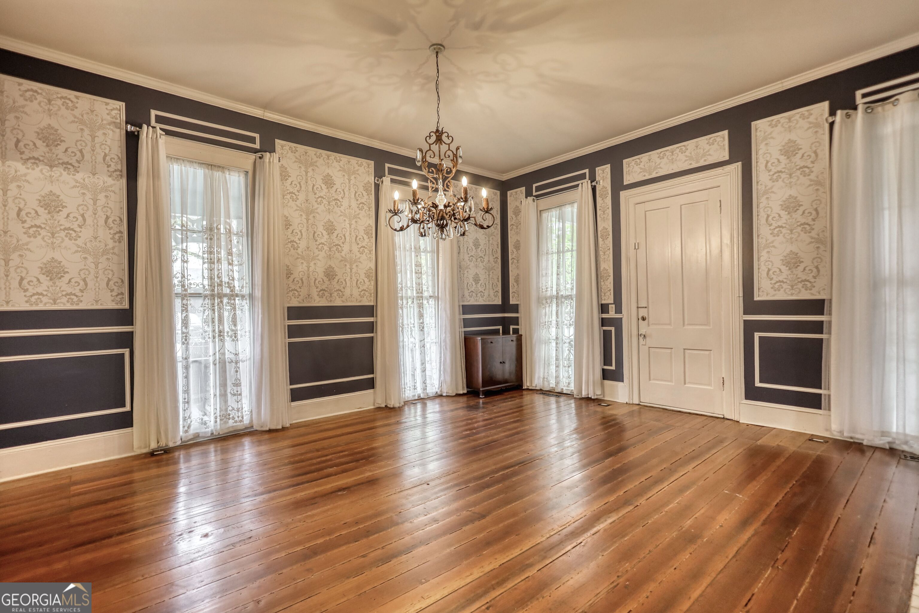 172 North 2nd Street Madison, GA 30650 - Photo 65 of 69 a view of a big room with wooden floor fireplace and windows