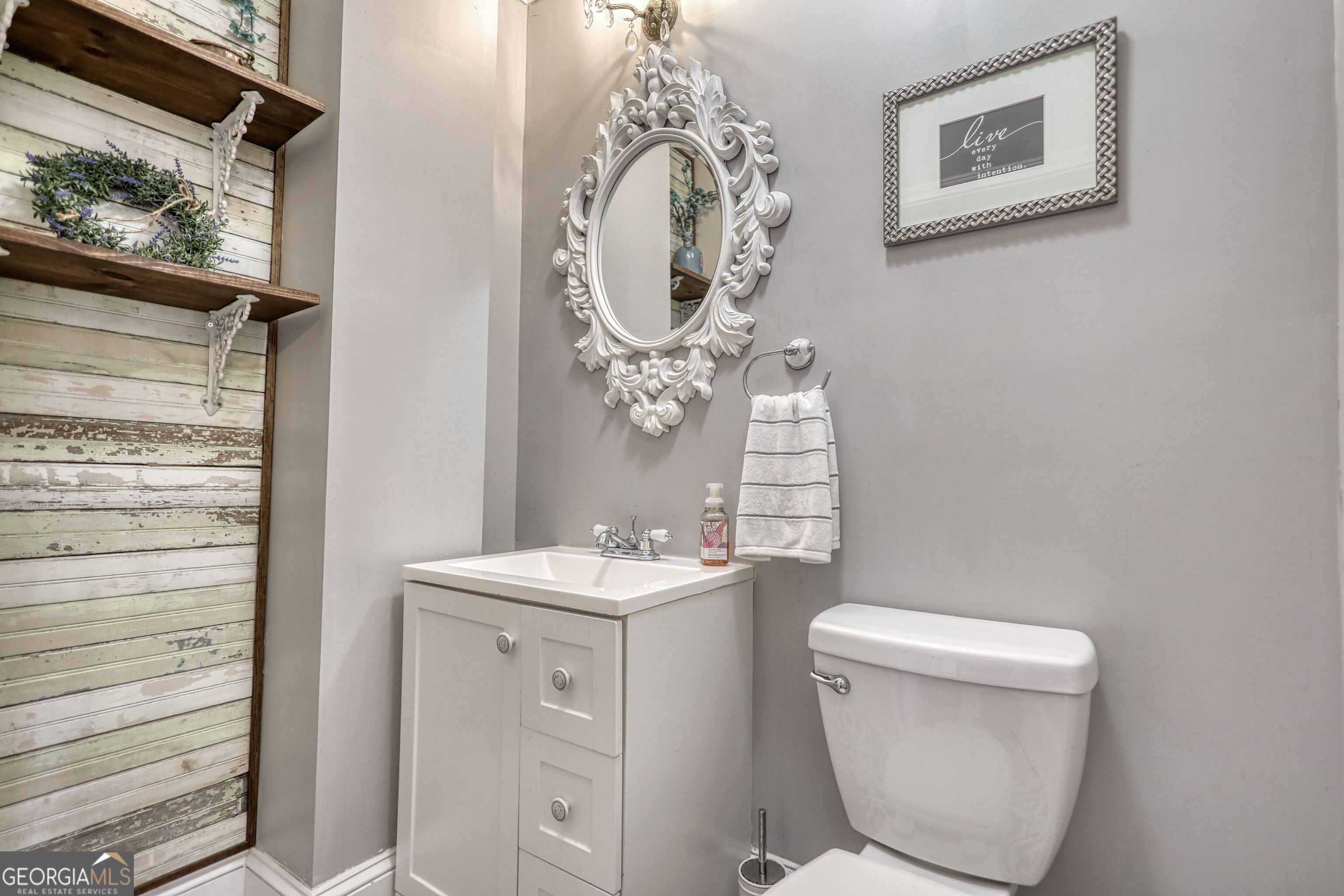 172 North 2nd Street Madison, GA 30650 - Photo 69 of 69 a bathroom with a toilet a sink and a mirror