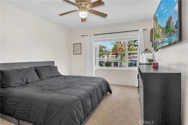 a bedroom with a large bed and a window