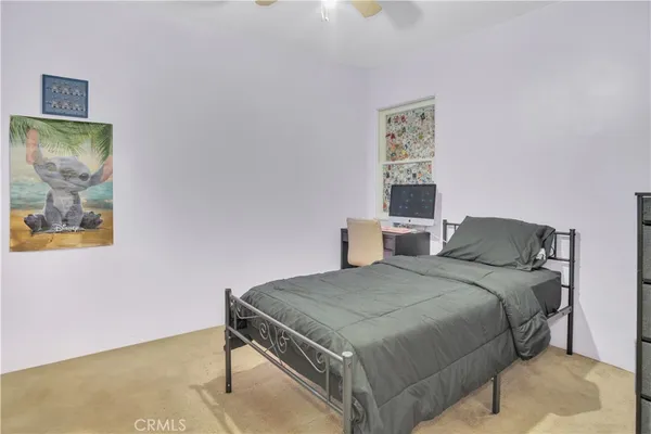 a bedroom with a bed and a painting on the wall