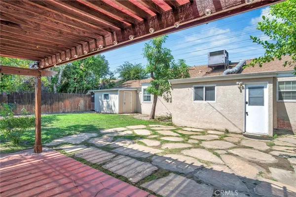 a view of a house with backyard and sitting area