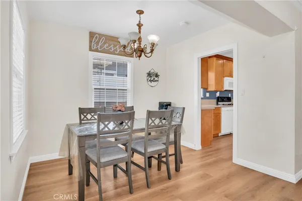 a view of a dining room with furniture and chandelier