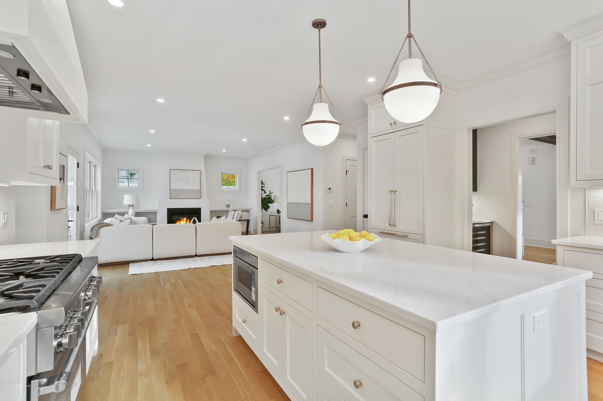 15 Barton Road Fairfield, CT 06824 - Photo 12 of 39 a large kitchen with stainless steel appliances a stove a sink dishwasher and a dining table with wooden floor