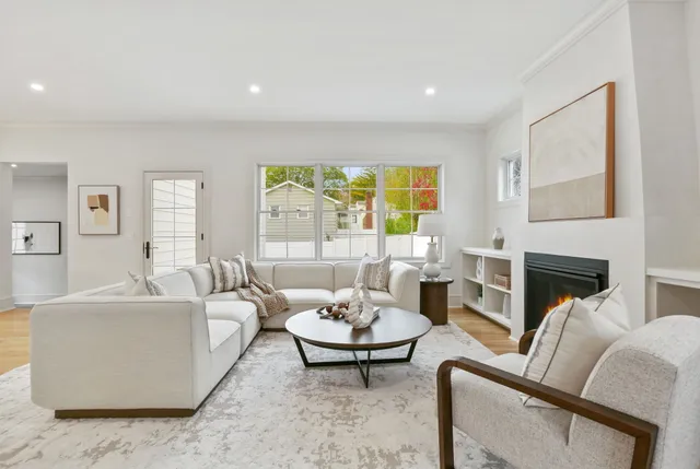 a living room with furniture and a fireplace