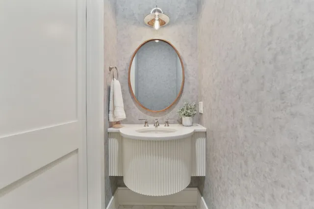 a bathroom with a sink and a mirror