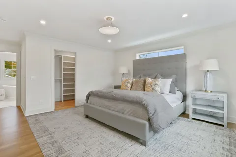 a bedroom with bed and a chandelier