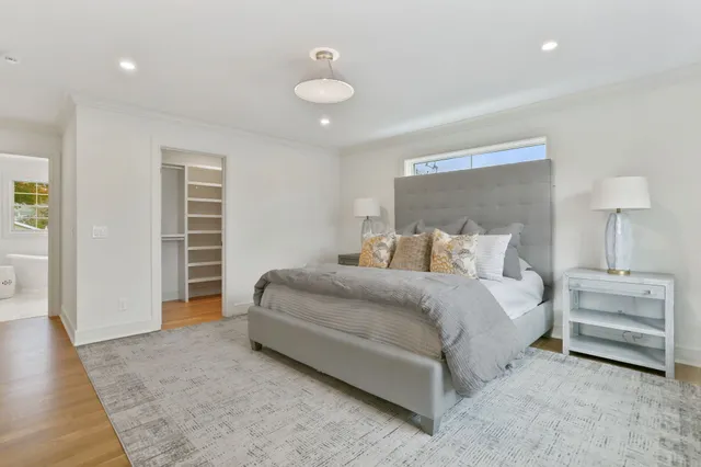 a bedroom with bed and a chandelier