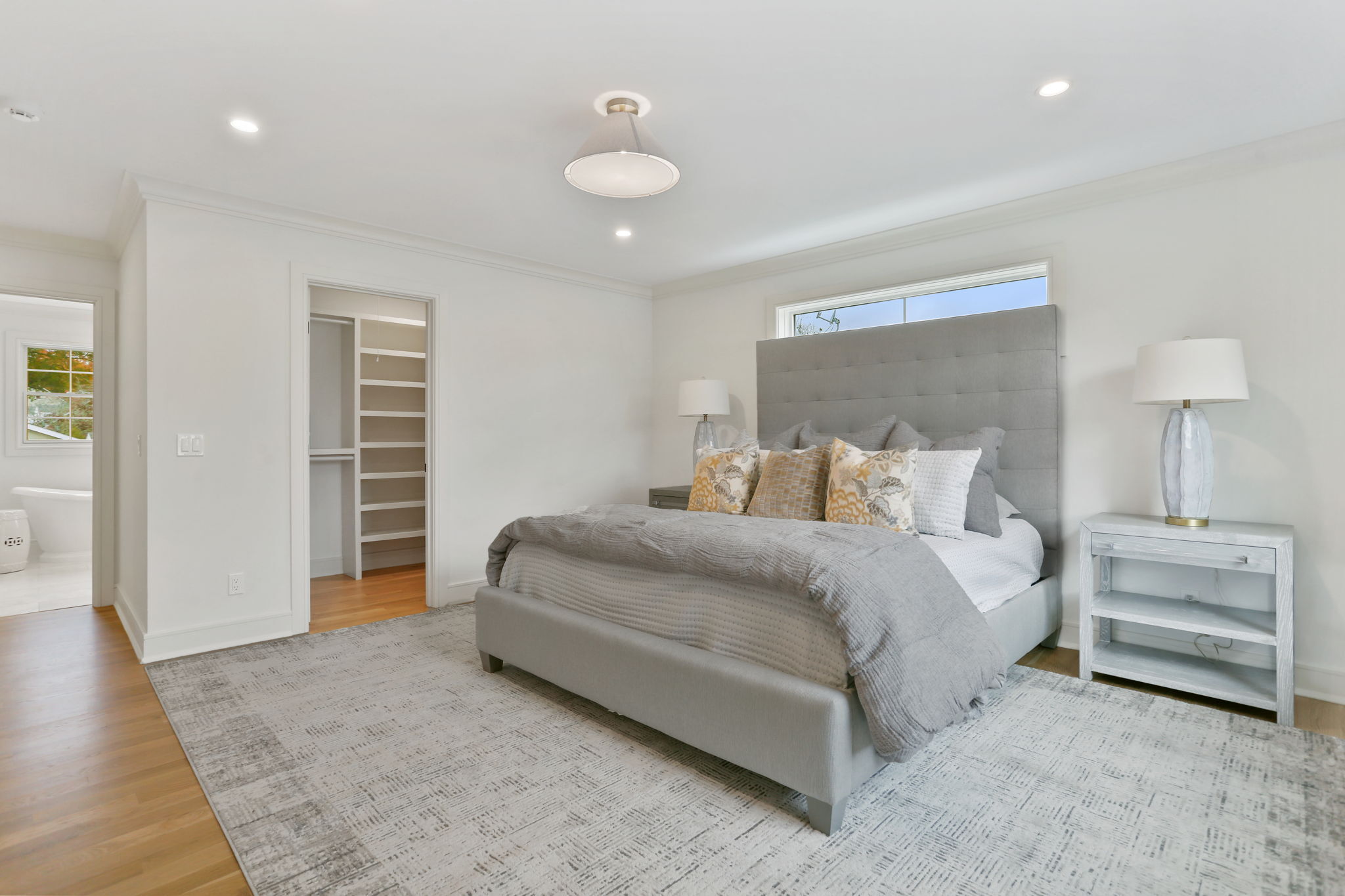 15 Barton Road Fairfield, CT 06824 - Photo 21 of 39 a bedroom with bed and a chandelier