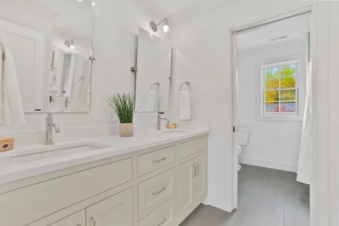 a bathroom with a double vanity sink and a mirror