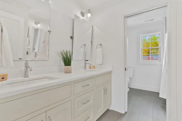 a bathroom with a double vanity sink and a mirror