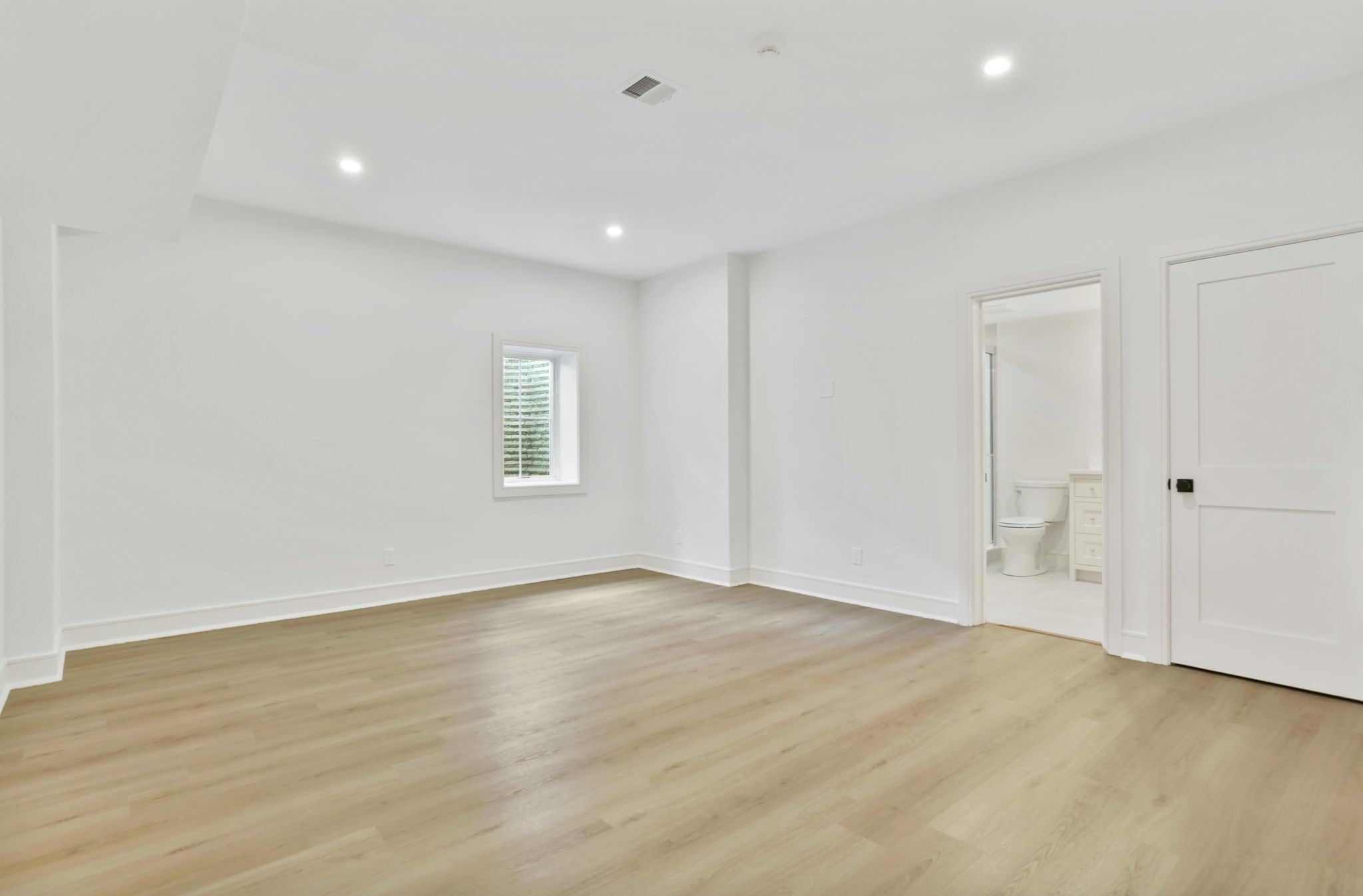 15 Barton Road Fairfield, CT 06824 - Photo 32 of 39 a view of an empty room with wooden floor and a window