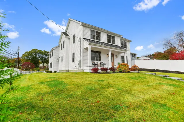 a view of a house with a backyard