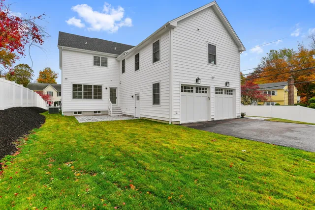 a view of a white house with a yard