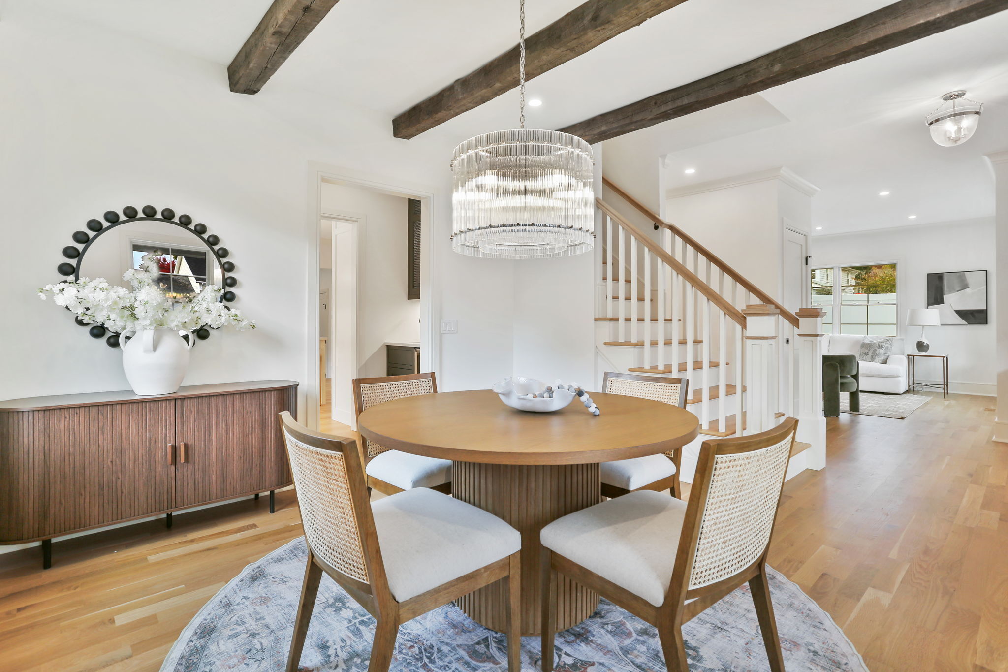 15 Barton Road Fairfield, CT 06824 - Photo 5 of 39 a dining room with wooden floor a chandelier a wooden table and chairs